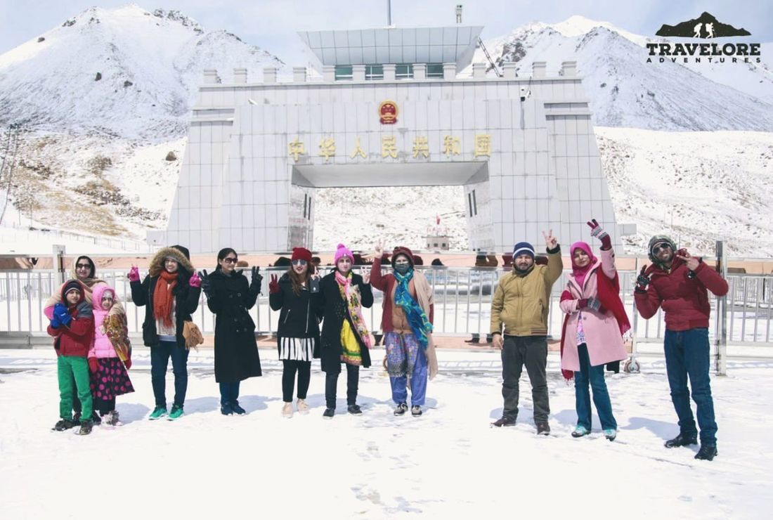 A Travelore group in the snow at the Khunjerab Pass border gate