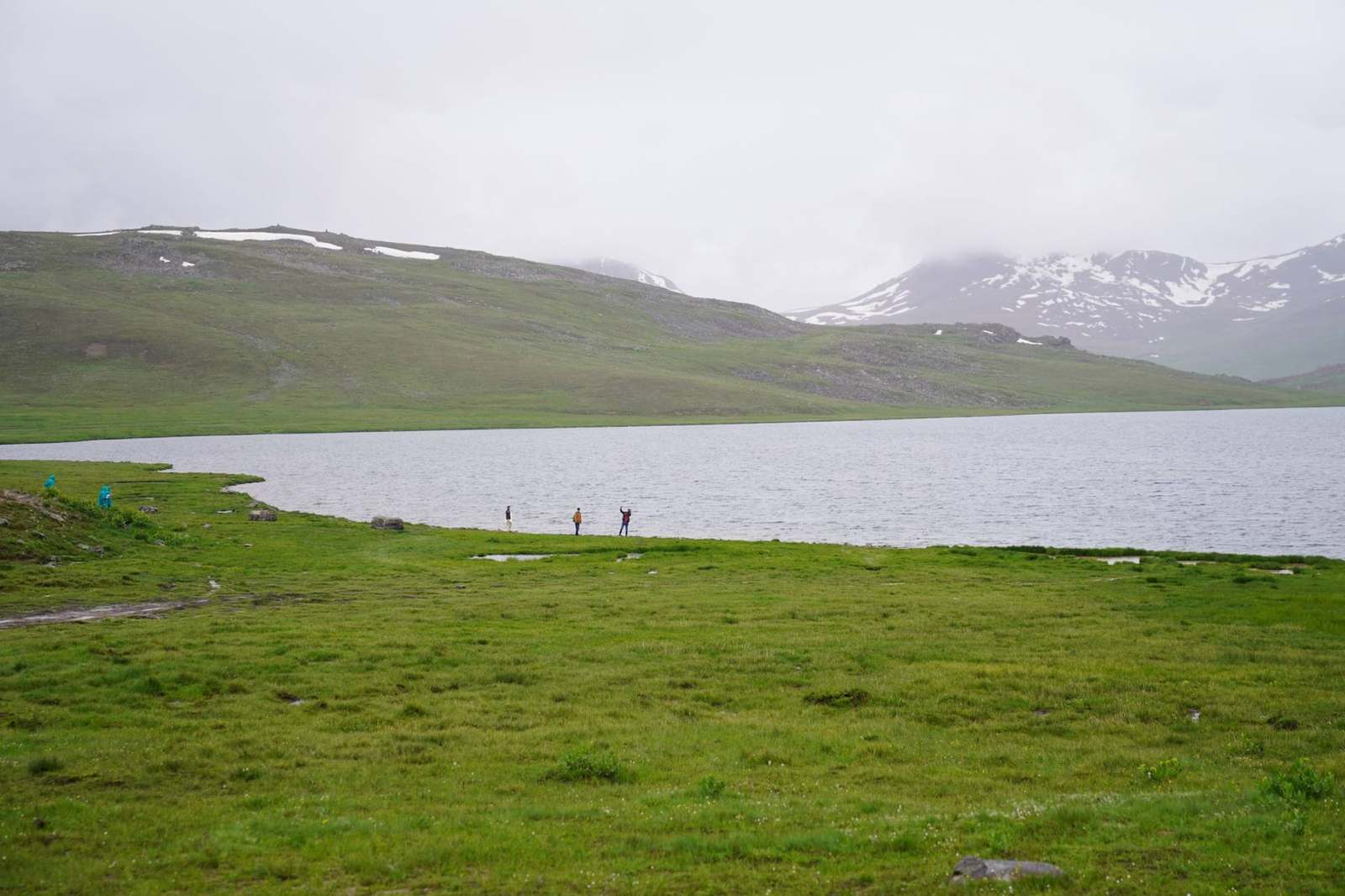 Travellers on the shore of Sheosar lake on the Deosai plains