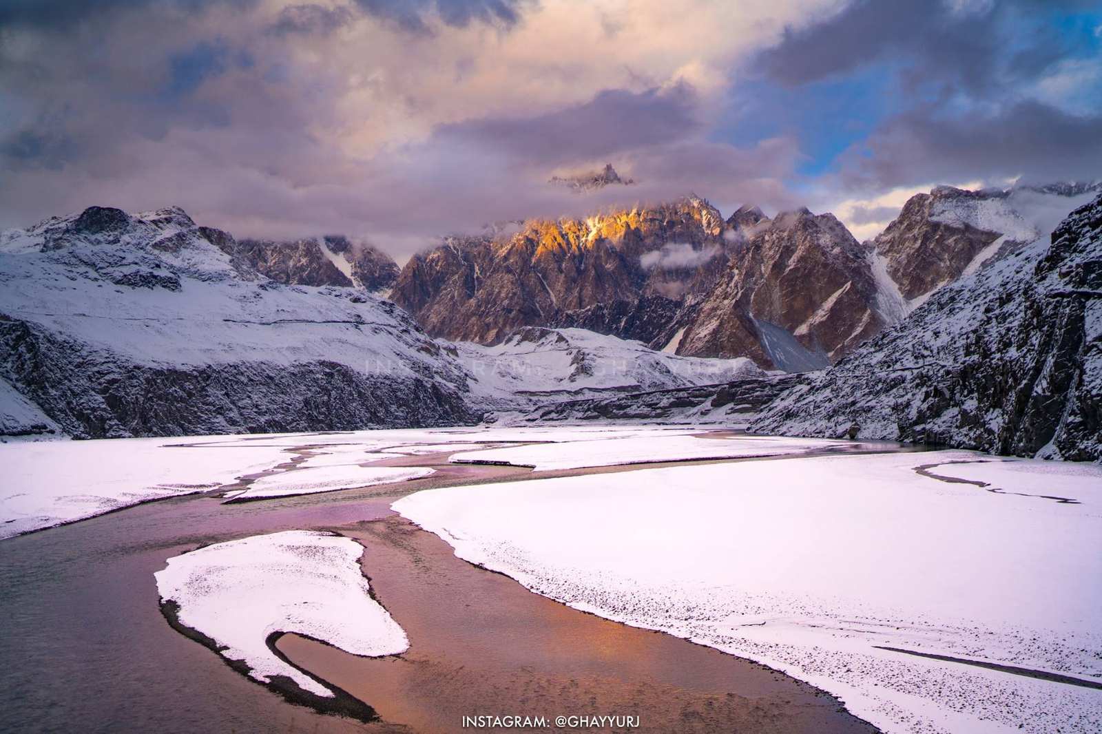 Fresh snow along the Hunza river below the Passu Cones at sunset
