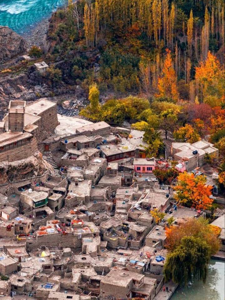 The old Altit village rooftops among autumn trees